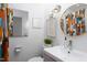 Modern bathroom with decorative mirror, a patterned shower curtain and an elongated toilet at 1109 Huntington Ave, Durham, NC 27707