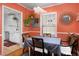Bright dining area featuring unique light fixture and wall mirror, adjacent to a modern kitchen at 1109 Huntington Ave, Durham, NC 27707
