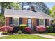 Well-maintained brick home with a neat lawn and colorful shrubbery enhancing curb appeal at 1109 Huntington Ave, Durham, NC 27707