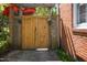 Wooden garden gate adorned with planters, adding charm and privacy to this outdoor space at 1109 Huntington Ave, Durham, NC 27707