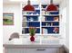 The bright kitchen features a quartz countertop island, custom shelving, and pendant lighting at 1109 Huntington Ave, Durham, NC 27707