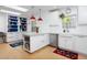 Bright kitchen featuring white cabinetry, an island with a quartz countertop, and stainless steel appliances at 1109 Huntington Ave, Durham, NC 27707