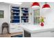 A kitchen featuring a built-in bookshelf, white cabinets and red pendant lights above the island at 1109 Huntington Ave, Durham, NC 27707