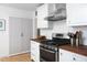 A kitchen showcasing stainless steel appliances, wooden countertops, and bright white subway tile at 1109 Huntington Ave, Durham, NC 27707