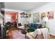 Cozy living room with a green sofa, stylish chairs, and a view into the adjacent dining area at 1109 Huntington Ave, Durham, NC 27707