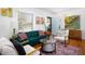 Bright living room with hardwood floors, modern furniture, and a view of the front entrance at 1109 Huntington Ave, Durham, NC 27707