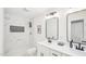 Bright bathroom featuring a double vanity with matte black hardware and a tiled shower with a niche at 111 Dunstan Ave, Durham, NC 27707