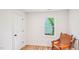 Cozy bedroom with hardwood floors and a leather chair beside the window at 111 Dunstan Ave, Durham, NC 27707