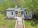 Charming single-story home featuring a bright yellow front door and well-maintained landscaping at 111 Dunstan Ave, Durham, NC 27707