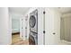 Hallway featuring a modern, stacked washer and dryer, and access to the bathroom and bedroom at 111 Dunstan Ave, Durham, NC 27707