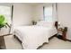 Inviting bedroom with natural light, soft white bedding, and elegant hardwood floors at 1116 Holburn Pl, Raleigh, NC 27610