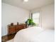 Bright bedroom showcasing a wooden dresser, light hardwood floors, and a cozy ceiling fan at 1116 Holburn Pl, Raleigh, NC 27610