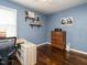 Charming blue bedroom with hardwood floors, a desk, and a vintage wooden dresser at 1116 Holburn Pl, Raleigh, NC 27610