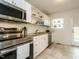 Bright kitchen featuring white cabinets, stainless steel appliances, and granite countertops at 1116 Holburn Pl, Raleigh, NC 27610