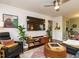 Open living room with a large television, comfy chair, entertainment center, and seamless access to the dining area at 1116 Holburn Pl, Raleigh, NC 27610