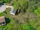 Lovely aerial view of a two-story home with spacious yard, deck, and garden in a wooded area at 1120 Shetland Ct, Raleigh, NC 27609