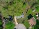 Aerial view of a charming home with a circular driveway, fenced yard, and lovely landscaping at 1120 Shetland Ct, Raleigh, NC 27609
