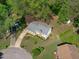 Aerial view of a charming home featuring a spacious backyard, deck, and mature trees at 1120 Shetland Ct, Raleigh, NC 27609