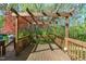 Cozy pergola-covered back deck with wood railing offers a serene outdoor living space at 1120 Shetland Ct, Raleigh, NC 27609