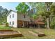 Large backyard with deck, mature trees, and garden beds, creating a peaceful outdoor retreat at 1120 Shetland Ct, Raleigh, NC 27609