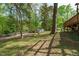 Spacious backyard with mature trees, a storage shed, and plenty of room for outdoor activities at 1120 Shetland Ct, Raleigh, NC 27609