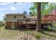 Spacious backyard featuring a charming deck, patio, and mature tree for added privacy at 1120 Shetland Ct, Raleigh, NC 27609