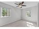 Bedroom with neutral walls, carpet, ceiling fan, and two windows at 1120 Shetland Ct, Raleigh, NC 27609