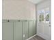 Inviting entryway with decorative wallpaper, wainscoting, and a door with glass panels at 1120 Shetland Ct, Raleigh, NC 27609