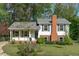 Charming two-story home featuring white siding, a brick chimney, and a well-maintained front lawn at 1120 Shetland Ct, Raleigh, NC 27609