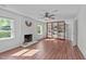 Bright living room with a decorative fireplace, a ceiling fan, and a built-in wooden bookshelf at 1120 Shetland Ct, Raleigh, NC 27609