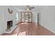 Bright living room with fireplace, wood floors, ceiling fan, and built in shelving at 1120 Shetland Ct, Raleigh, NC 27609