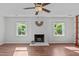Bright living room featuring a fireplace, two windows, and hard surface floors at 1120 Shetland Ct, Raleigh, NC 27609