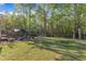Expansive backyard featuring a gazebo, fire pit with chairs, and mature trees at 119 Wolf Creek Dr, Wendell, NC 27591