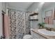 Full bathroom featuring a granite countertop, floral shower curtain, and tiled floors at 119 Wolf Creek Dr, Wendell, NC 27591
