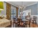 Dining room with stylish chandelier, seating for six, and window at 119 Wolf Creek Dr, Wendell, NC 27591