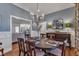 Formal dining room with stylish chandelier, seating for six, and views to other living areas at 119 Wolf Creek Dr, Wendell, NC 27591