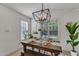 Sunlit dining area featuring a wooden table and modern light fixture at 119 Wolf Creek Dr, Wendell, NC 27591