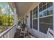 Inviting front porch with rocking chairs and a view of lush greenery at 119 Wolf Creek Dr, Wendell, NC 27591