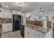 Open kitchen with granite counters, stainless sink, and black appliances at 119 Wolf Creek Dr, Wendell, NC 27591
