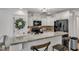 Open concept kitchen has granite counters, white cabinets, and black appliances at 119 Wolf Creek Dr, Wendell, NC 27591