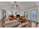 Cozy living room with a fireplace, ceiling fan, and hardwood floors throughout at 119 Wolf Creek Dr, Wendell, NC 27591