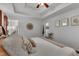 Comfortable main bedroom with a tray ceiling, ceiling fan, and hardwood floors at 119 Wolf Creek Dr, Wendell, NC 27591