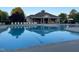A refreshing community pool is surrounded by lounge chairs and a covered pavilion at 120 Putters Ct, Durham, NC 27703
