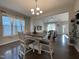 An open floor plan showcases a dining area with wood floors leading to a living room at 120 Putters Ct, Durham, NC 27703