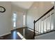 Inviting foyer with hardwood floors, staircase with white spindles, and natural light from the front door at 120 Putters Ct, Durham, NC 27703