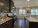 Modern kitchen with stainless steel appliances, granite counters and dark wood cabinets at 120 Putters Ct, Durham, NC 27703