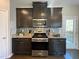 Bright kitchen boasts stainless steel appliances, granite countertops, and backsplash at 120 Putters Ct, Durham, NC 27703