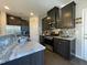 Kitchen featuring stainless steel appliances, granite countertops, and dark wood cabinets at 120 Putters Ct, Durham, NC 27703