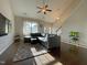 Comfortable living room with vaulted ceiling, hardwood floors, neutral decor, and front-facing windows at 120 Putters Ct, Durham, NC 27703