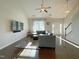 Living room with vaulted ceiling, hardwood floors, neutral decor, large sectional sofa, and front entrance access at 120 Putters Ct, Durham, NC 27703